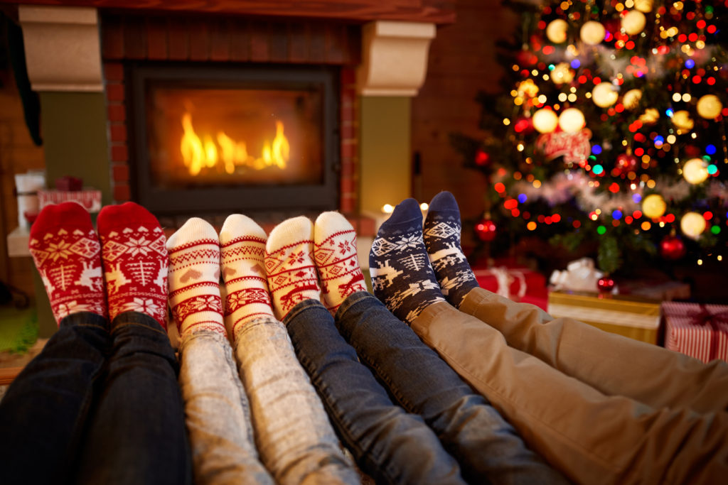 Family with Their Feet up by a Fire