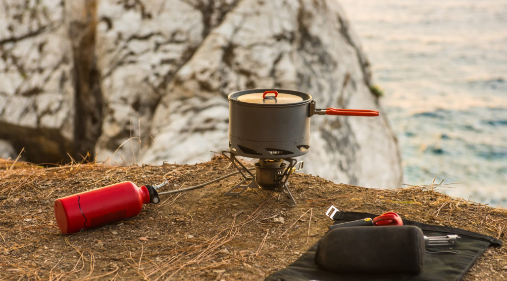 Tourist equipment and tools: camping gas over sea background