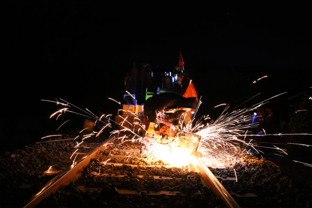 Thermit welding works on a railroad during night time