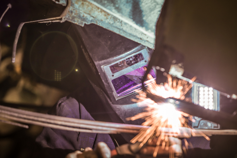 welder welding together dissimilar metals