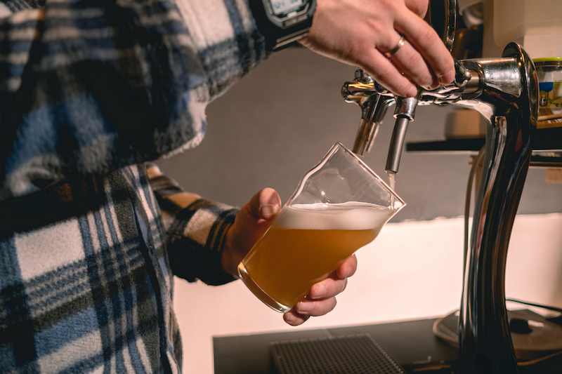 Person dispensing a beer