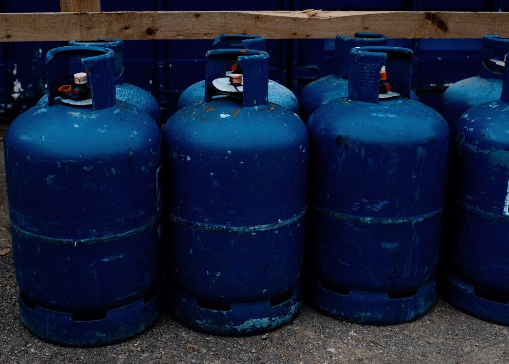A line of dark blue, small gas bottles