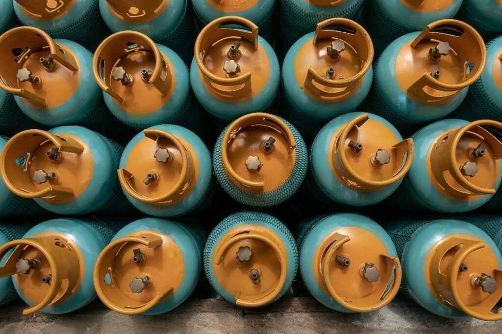 A top down image, showing the top of gas bottles, each bottle has a yellow top and a teal body