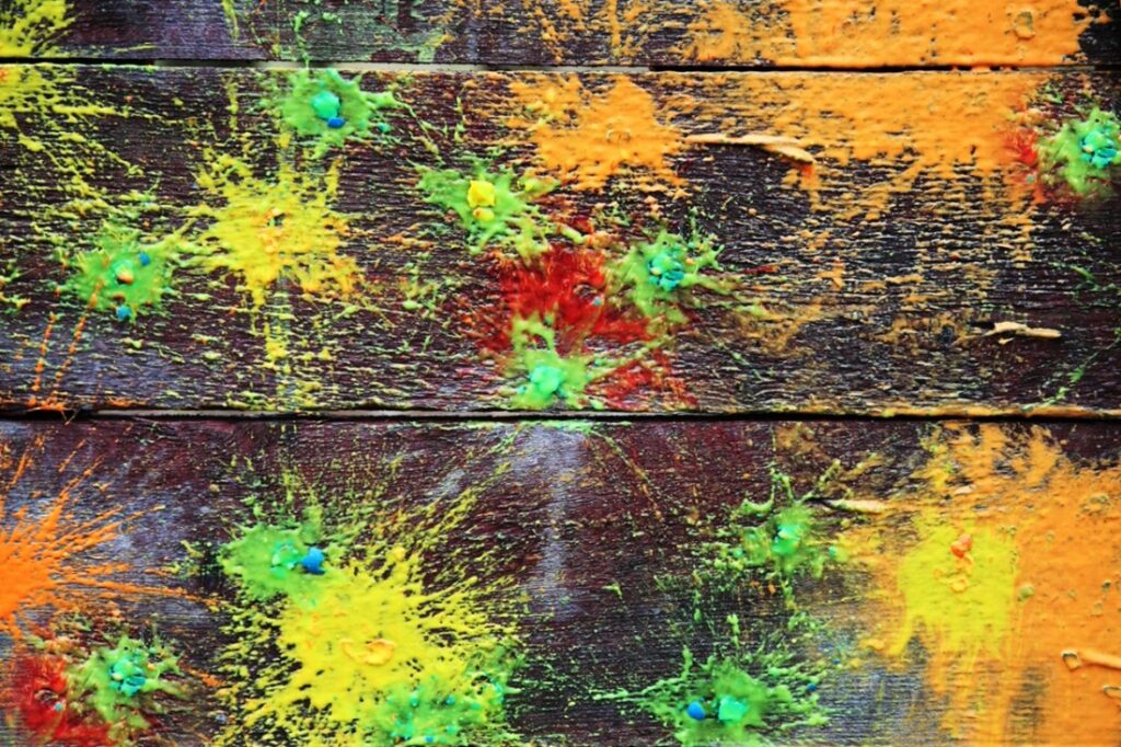 Paint splattered on a wood surface