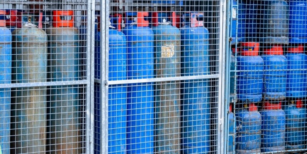 A blue cylinder in a cage