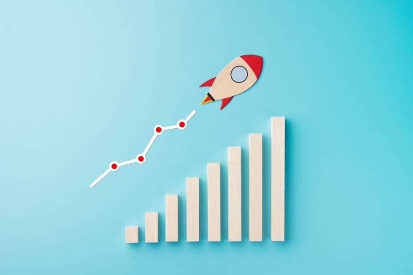A rocket flying to the top of a graph
