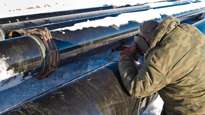 person welding in snow