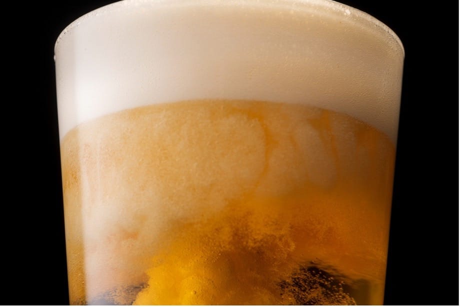 A glass of beer with foam