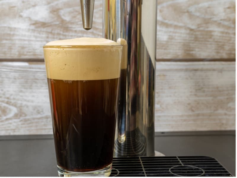 A glass of beer with foam in it