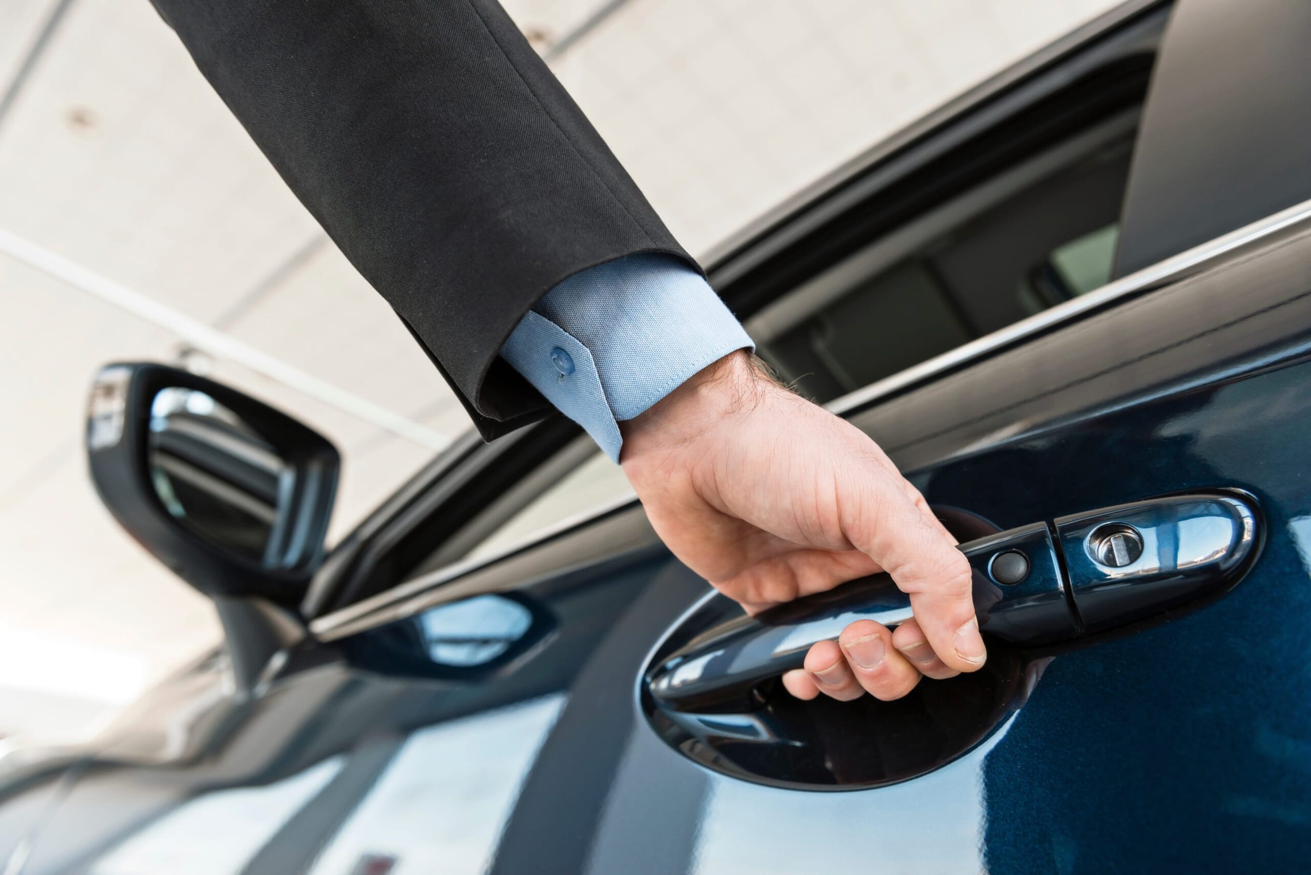 Close up photo of young man hand touching and openning new car.